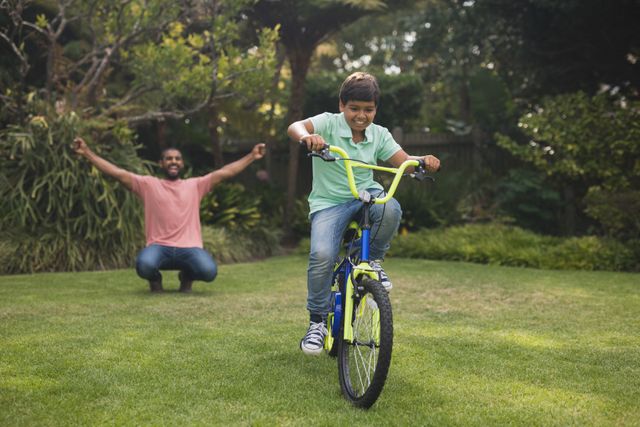 Father enthusiastically cheering for his son as he rides a bicycle in a park. Perfect for illustrating family bonding, outdoor activities, childhood milestones, and supportive parenting. Ideal for use in advertisements, parenting blogs, educational materials, and lifestyle articles.