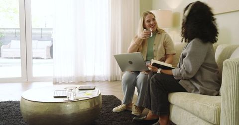 Diverse Women Relaxing Together in Modern Living Room Environment