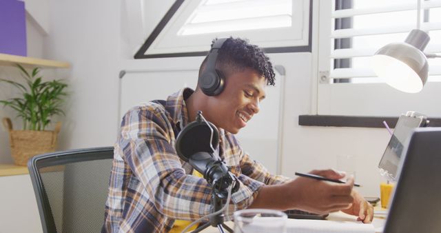 Young Man Recording podcast at Home Office wearing Headphones - Download Free Stock Images Pikwizard.com