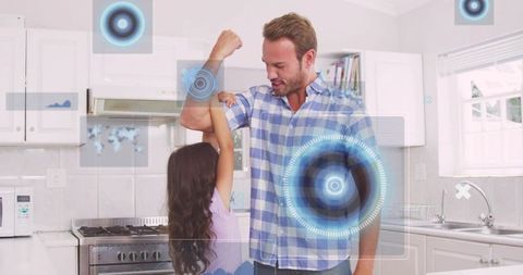 Father and daughter bonding through augmented reality play in modern home kitchen