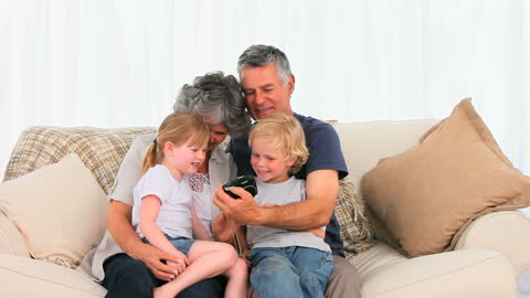 Cheerful Family Capturing Memories on Couch