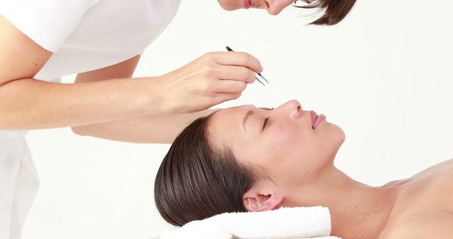 Beautician Performing Eyebrow Maintenance on Relaxed Woman - Download Free Stock Images Pikwizard.com