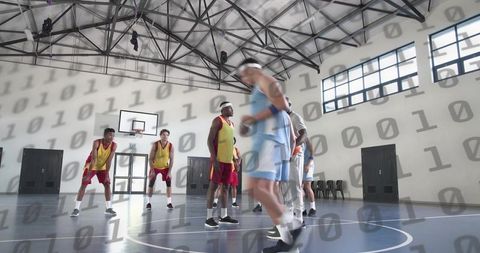 Indoor basketball scrimmage with dribbling guard, team defense, analytics overlay