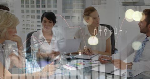 Diverse business team analyzing financial data with graphs overlay