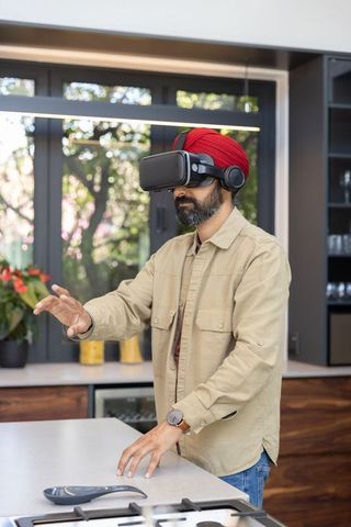 Man engaging in virtual reality with vr headset and wireless headphones