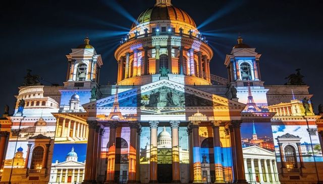Neoclassical cathedral projection mapping at night showing dome, columns, towers in lightshow