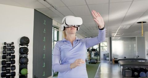 Woman Participating in Virtual Reality Therapy at Rehabilitation Center