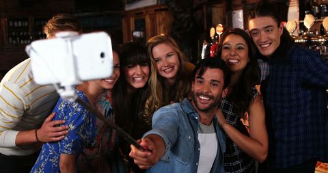 Diverse Friends Smiling for Selfie at Social Gathering