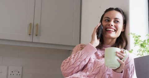 Woman in Pink Sweater Having Phone Conversation Enjoying Coffee
