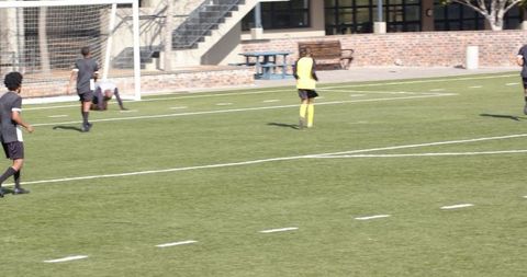 Soccer Players Competing in Intense Match on Field