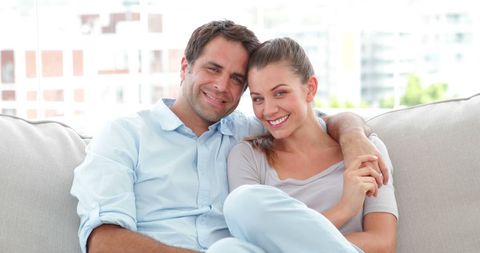 Happy Couple Relaxed on Comfortable Couch at Home