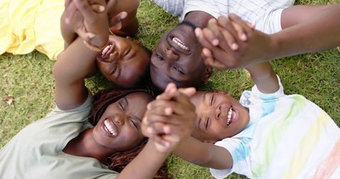 Joyful African American Family Laughing and Holding Hands