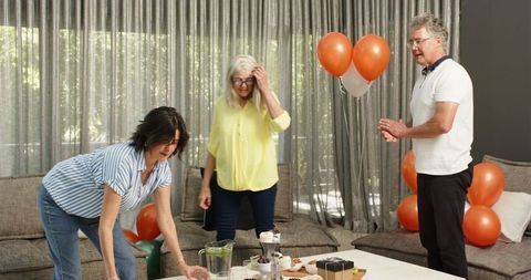 Team collaborating in office lounge for celebration