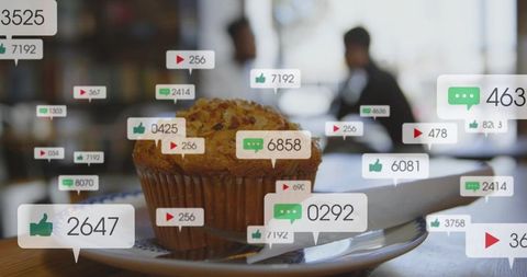 Golden muffin sitting on cafe plate with floating social media likes comments and views