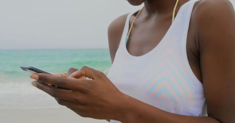 African American Woman Using Mobile Phone on Beach - Download Free Stock Images Pikwizard.com