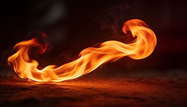 Ribbon Flame Motion Sweeping Across Textured Ground with Trailing Embers and Smoke