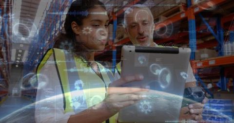 Warehouse team using tablet with augmented reality dashboards for inventory and logistics