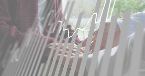 Daughter holding elderly mother's hands offering comfort during caregiving visit