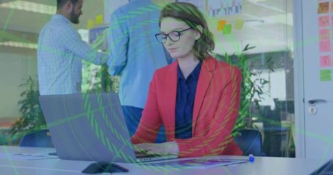 Woman in Modern Office Using Laptop during Teamwork Session