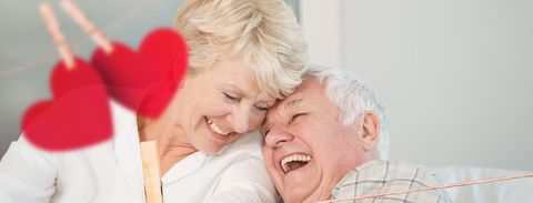 Elderly Couple Laughing Together with Heart Decoration