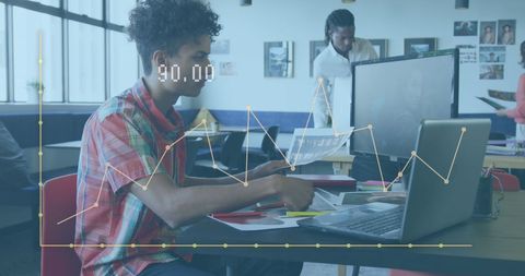 Young Professional Analyzing Financial Data in Modern Office