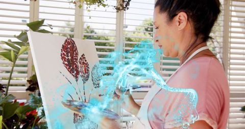 Mature artist painting botanical canvas with turquoise creative glow in sunlit studio