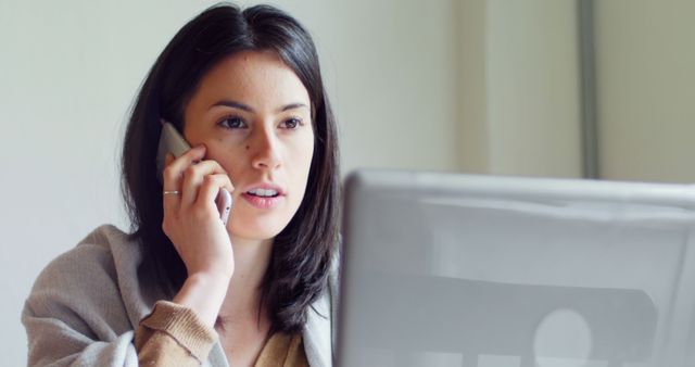 Businesswoman Handling Call While Working on Computer - Download Free Stock Images Pikwizard.com