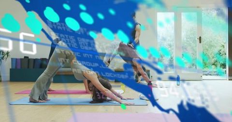 Woman practicing downward dog in sunlit group yoga class with blue digital overlay