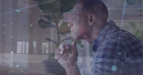 Contemplative man amidst digital connection overlay