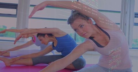 Active Women Practicing Yoga Indoors Incorporating Technology