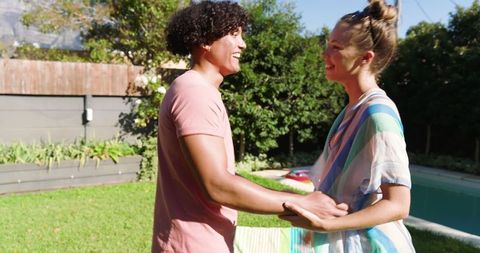 Happy Multicultural Couple Enjoying Summer Day by Pool