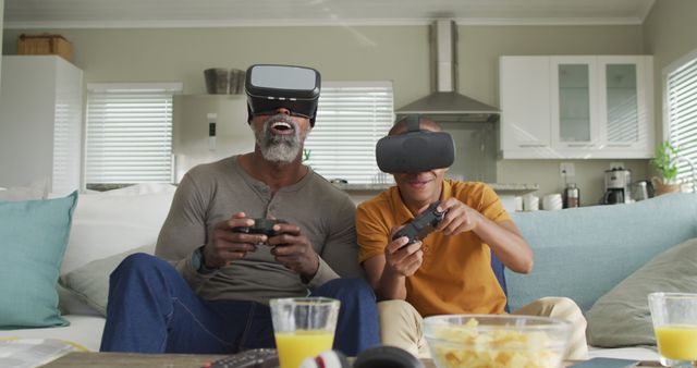 Father and son enjoy an exciting video game session using VR headsets. Perfect for acknowledging technology in family activities, promoting gaming products, or illustrating family moments at home.