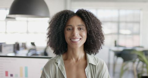 Smiling Businesswoman in Modern Office Looking Confident