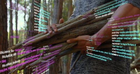 Man carrying wooden sticks in forest with digital code overlay