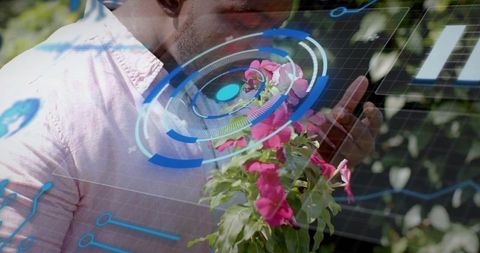 Man using smartphone with augmented reality hud in backyard garden with pink flowers