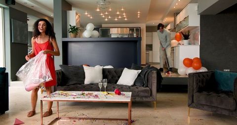 Interracial Couple Tidying After Party Celebration at Home