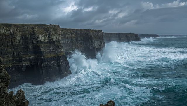Dramatic rock cliffs facing roaring ocean