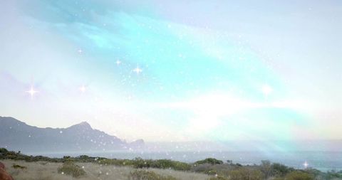 Ethereal blue-green cloud over coastal landscape