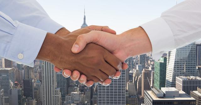Digital composite of Cropped image of business people doing handshake against city