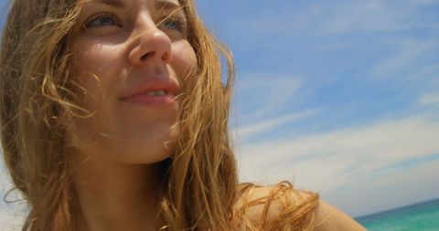 Caucasian Woman Smiling by Ocean on Sunny Day - Download Free Stock Images Pikwizard.com