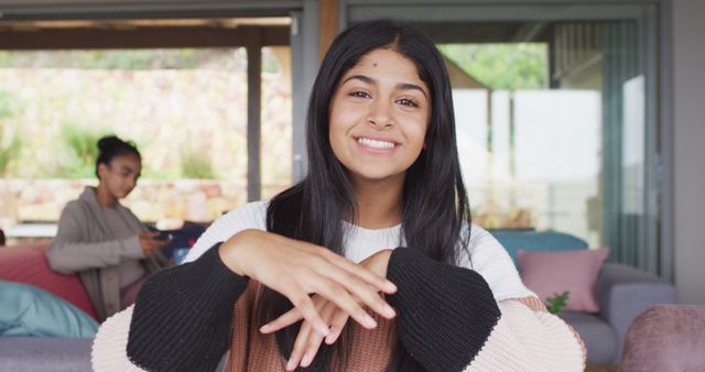 Young Woman Smiling at Home, Friend in Background - Download Free Stock Images Pikwizard.com