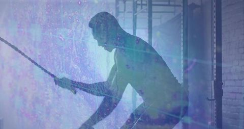 Man Exercising with Battle Ropes in Gym with Digital Energy Overlay
