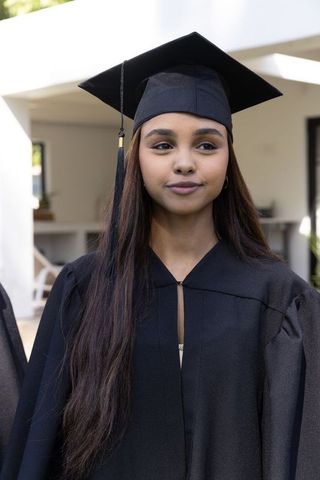 Proud hispanic graduate shining on commencement day