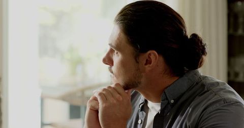Man writing in notebook at home office with laptop and coffee