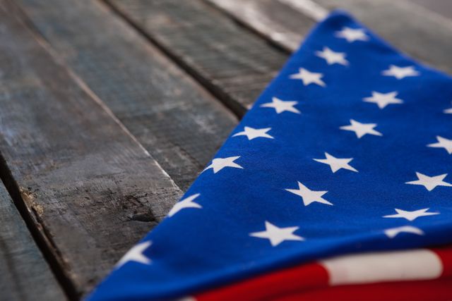 Folded American Flag on Rustic Wooden Table - Download Free Stock Photos Pikwizard.com