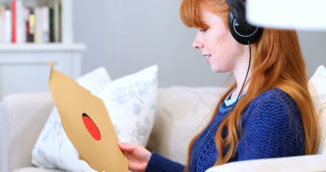 Young Woman Wearing Headphones Relaxing at Home Listening to Vinyl Record - Download Free Stock Images Pikwizard.com