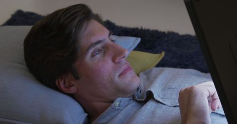 Relaxed Man Enjoying Tablet in Cozy Living Room Setting