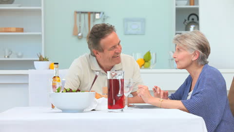 Happy Senior Couple Enjoying Relaxing Lunch at Home