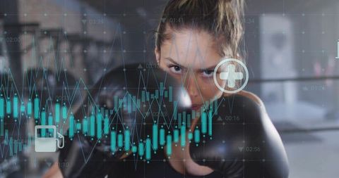Female boxer throwing powerful punch with digital fitness data overlay and teal analytics