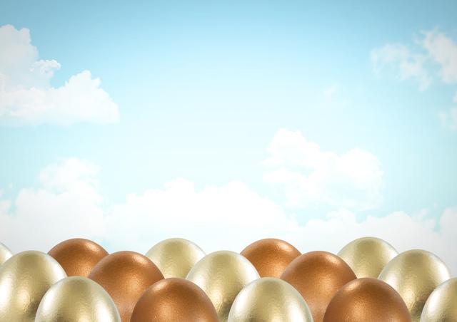 Golden and bronze Easter eggs situated in the foreground with a blue sky and clouds. Ideal for spring themes, Easter celebrations, holiday greeting cards, festive advertisements, or seasonal promotions.
